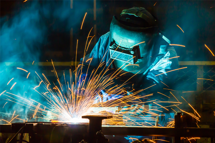 A professional fabrication welder welding together a product